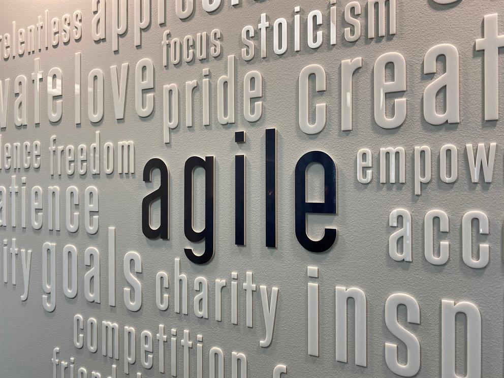 A wall with various words across it